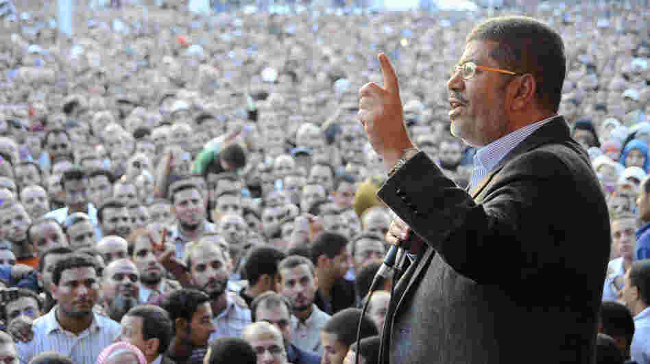 Egyptian President Mohammed Morsi speaks to supporters outside the presidential palace in Cairo on Nov. 23, a day after he issued decrees that gave him sweeping powers. Egyptian President Mohammed Morsi speaks to supporters outside the presidential palace in Cairo on Nov. 23, a day after he issued decrees that gave him sweeping powers.