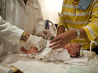 Rabbi A. Romi Cohn, a noted mohel, prepares an infant for circumcision at Congregation Shaare Zion in Brooklyn on Sept. 4. Cohn opposes a New York City rule requiring parental consent for a type of circumcision ritual practiced by some Orthodox Jews. Rabbi A. Romi Cohn, a noted mohel, prepares an infant for circumcision at Congregation Shaare Zion in Brooklyn on Sept. 4. Cohn opposes a New York City rule requiring parental consent for a type of circumcision ritual practiced by some Orthodox Jews.