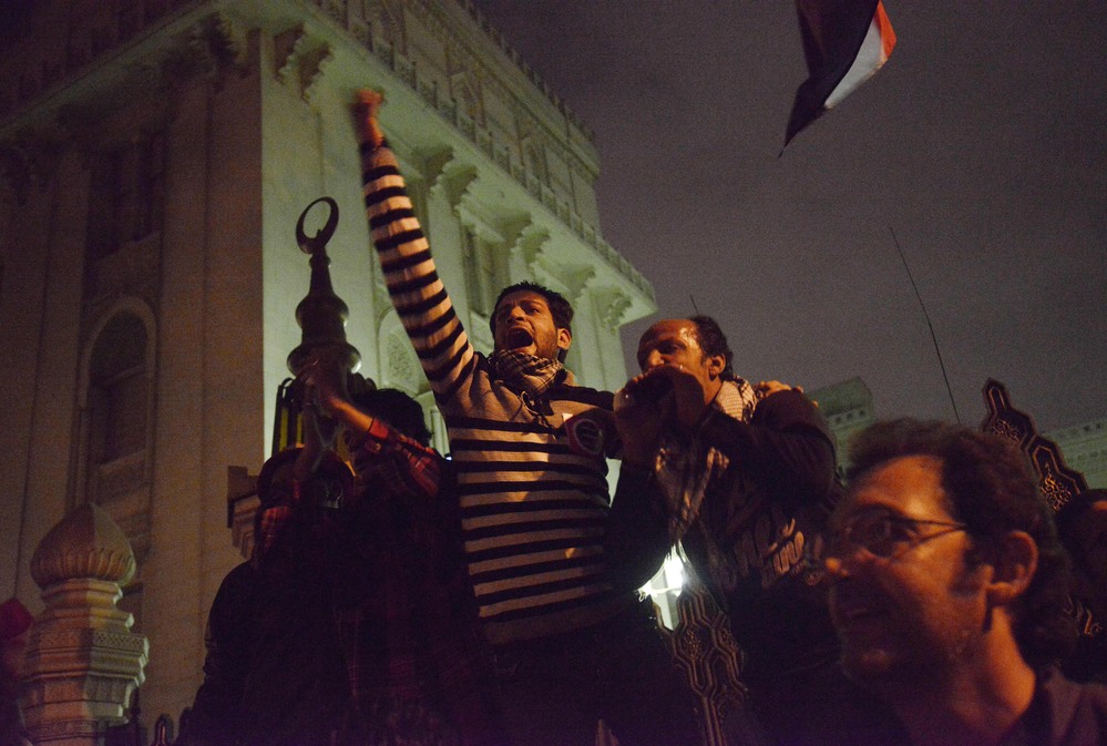 Egyptian protesters shout slogans as they demonstrate outside of the presidential palace in Cairo Tuesday.