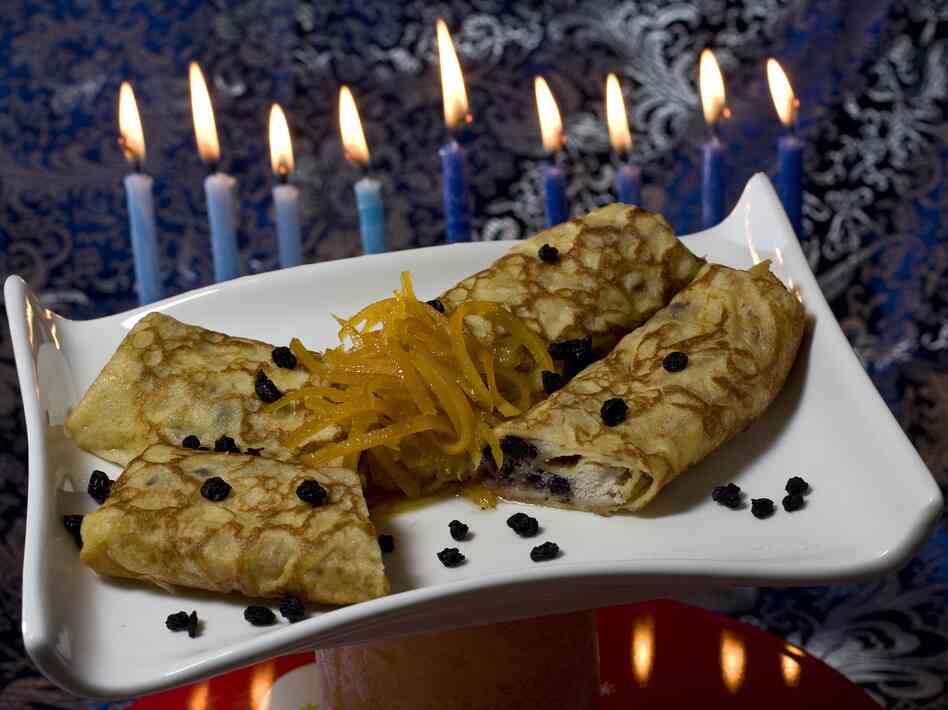 Lemon and dried blueberry blintzes, filled with creamy ricotta cheese, provide a tasty way to serve dairy and honor Judith for Hanukkah.