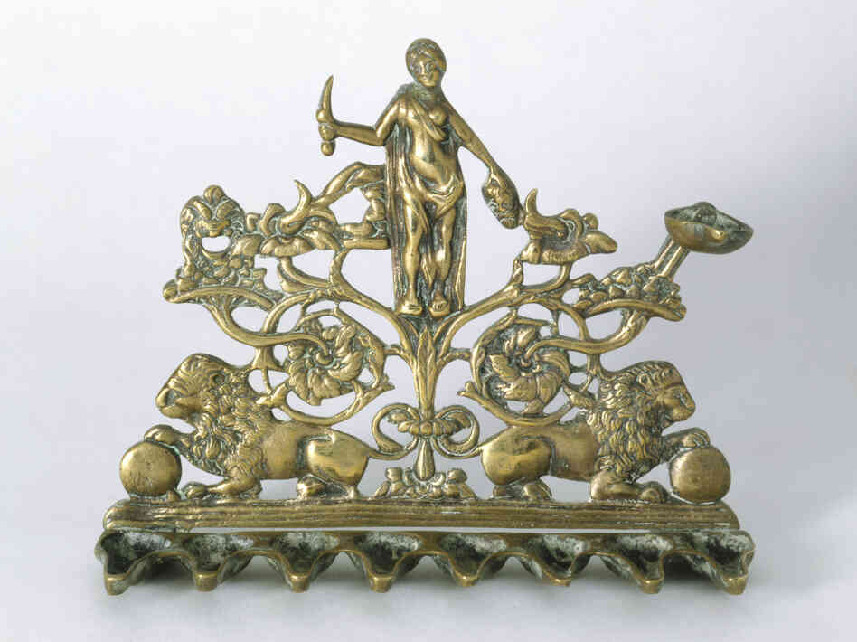 This Hanukkah lamp, made in Italy in the 19th century, depicts Judith holding a sword in one hand and the severed head of Holofernes in the other. This Hanukkah lamp, made in Italy in the 19th century, depicts Judith holding a sword in one hand and the severed head of Holofernes in the other.