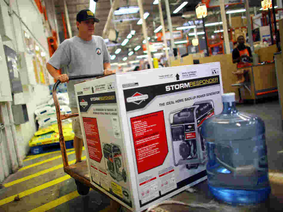Home Depot has long offered credit cards, partly to serve customers who have just suffered major house damage. The company has recently widened those efforts. Here, a Tampa, Fla., customer buys a generator and bottled water, preparing for Tropical Storm Isaac's arrival in August.