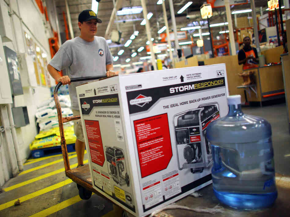 Home Depot has long offered credit cards, partly to serve customers who have just suffered major house damage. The company has recently widened those efforts. Here, a Tampa, Fla., customer buys a generator and bottled water, preparing for Tropical Storm Isaac's arrival in August.