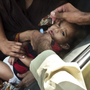 A child is inoculated with the polio vaccine at a traffic checkpoint just outside Pakistan's capital, Islamabad. Roadside vaccinations help health workers reach children in mobile populations.
