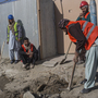 Afghan laborers work on a roads project last month in Kabul. A huge project to fix the city's roads and sewers is causing huge headaches.