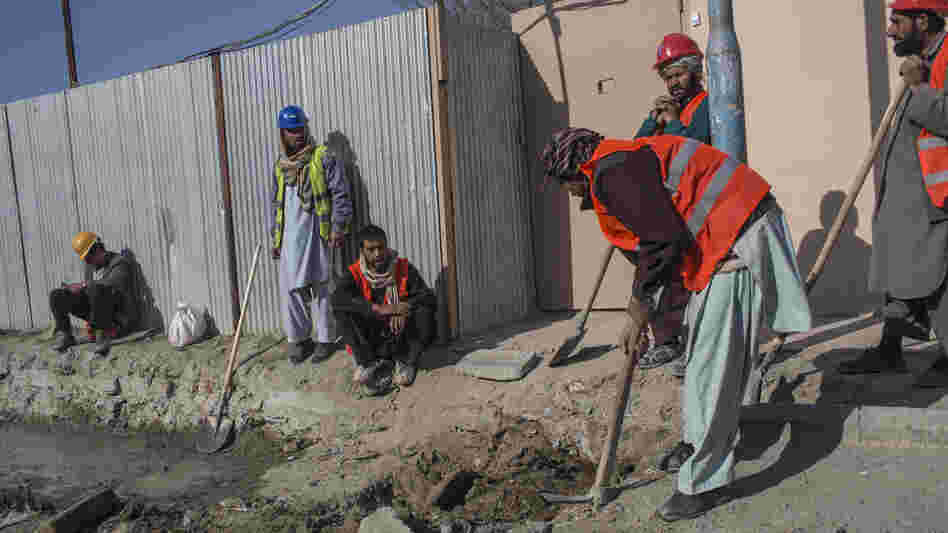 Afghan laborers work on a roads project last month in Kabul. A huge project to fix the city's roads and sewers is causing huge headaches. Afghan laborers work on a roads project last month in Kabul. A huge project to fix the city's roads and sewers is causing huge headaches.