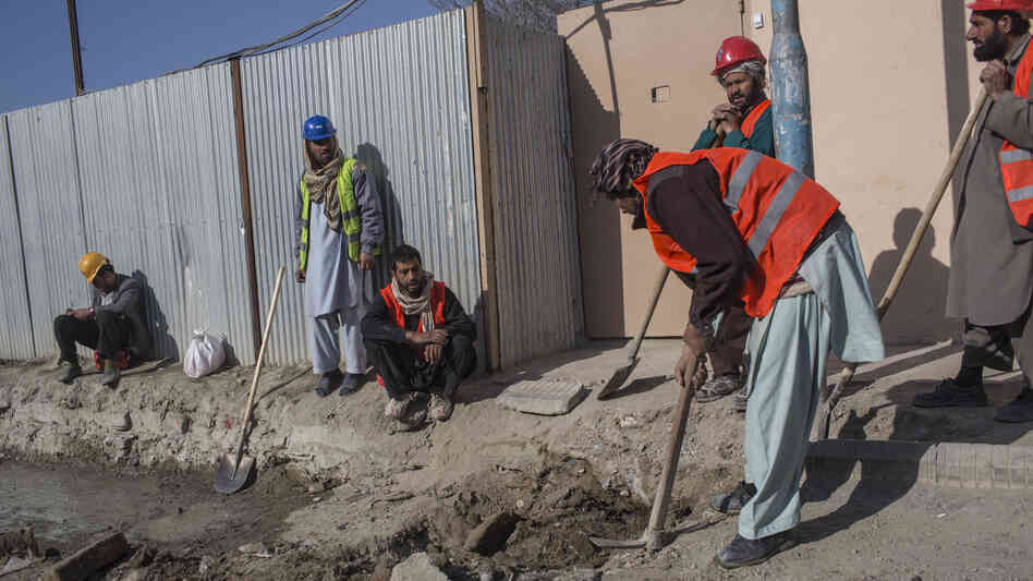 Afghan laborers work on a roads project last month in Kabul. A huge project to fix the city's roads and sewers is causing huge headaches. Afghan laborers work on a roads project last month in Kabul. A huge project to fix the city's roads and sewers is causing huge headaches.
