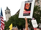 A demonstrator carries a sign calling people to "resist" President Barack Obama perceived socialist policies during a march of supporters of the conservative Tea Party movement in Washington. A demonstrator carries a sign calling people to "resist" President Barack Obama perceived socialist policies during a march of supporters of the conservative Tea Party movement in Washington.