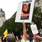 A demonstrator carries a sign calling people to "resist" President Barack Obama perceived socialist policies during a march of supporters of the conservative Tea Party movement in Washington.