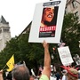 A demonstrator carries a sign calling people to "resist" President Barack Obama perceived socialist policies during a march of supporters of the conservative Tea Party movement in Washington. A demonstrator carries a sign calling people to "resist" President Barack Obama perceived socialist policies during a march of supporters of the conservative Tea Party movement in Washington.
