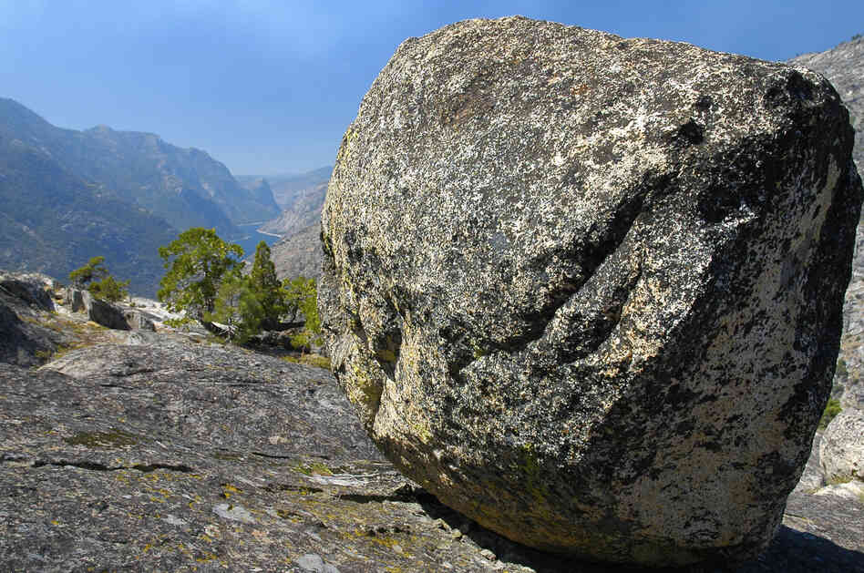 A glacial erratic with the Hetch-Hetchy Reservoir in the background. A glacial erratic with the Hetch-Hetchy Reservoir in the background.