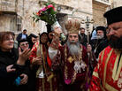 Patriarch Theophilos III, the Greek Orthodox patriarch of Jerusalem (center), splashes holy water toward worshippers after the washing of the feet ceremony in front of the Church of the Holy Sepulcher in Jerusalem in 2009, during Easter celebrations. A crisis was narrowly averted recently when the church's $2.3 million water bill was waived. Patriarch Theophilos III, the Greek Orthodox patriarch of Jerusalem (center), splashes holy water toward worshippers after the washing of the feet ceremony in front of the Church of the Holy Sepulcher in Jerusalem in 2009, during Easter celebrations. A crisis was narrowly averted recently when the church's $2.3 million water bill was waived.
