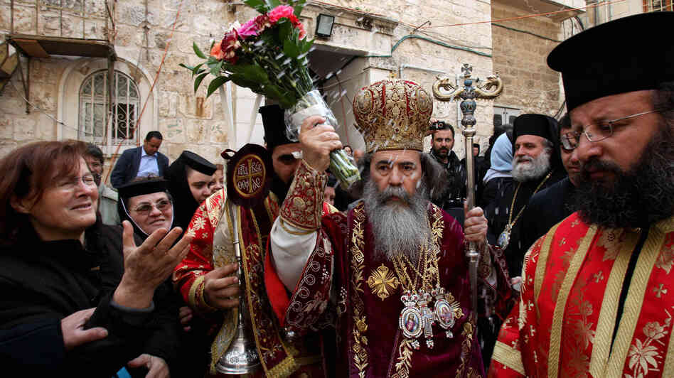 Patriarch Theophilos III, the Greek Orthodox patriarch of Jerusalem (center), splashes holy water toward worshippers after the washing of the feet ceremony in front of the Church of the Holy Sepulcher in Jerusalem in 2009, during Easter celebrations. A crisis was narrowly averted recently when the church's $2.3 million water bill was waived. Patriarch Theophilos III, the Greek Orthodox patriarch of Jerusalem (center), splashes holy water toward worshippers after the washing of the feet ceremony in front of the Church of the Holy Sepulcher in Jerusalem in 2009, during Easter celebrations. A crisis was narrowly averted recently when the church's $2.3 million water bill was waived.