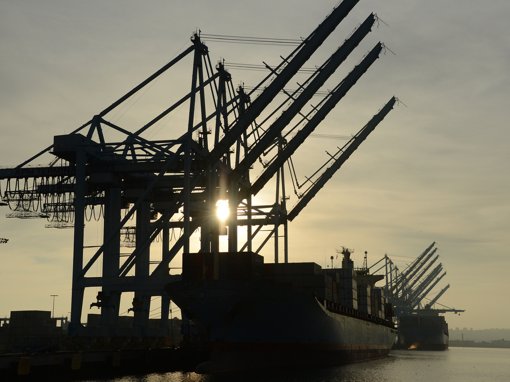 Work can start again: This ship, loaded with containers, was sitting beneath idle cranes Tuesday at the Port of Los Angeles.