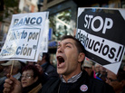 A demonstrator shouts during a protest against housing evictions in Madrid last month. The sign to his right reads, "Stop evictions." A demonstrator shouts during a protest against housing evictions in Madrid last month. The sign to his right reads, "Stop evictions."