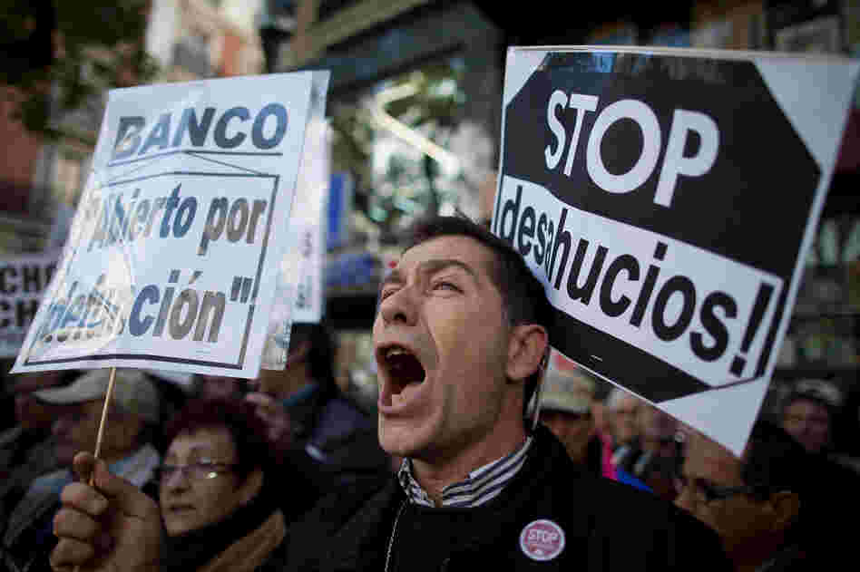 A demonstrator shouts during a protest against housing evictions in Madrid last month. The sign to his right reads, "Stop evictions." A demonstrator shouts during a protest against housing evictions in Madrid last month. The sign to his right reads, "Stop evictions."