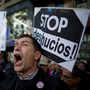 A demonstrator shouts during a protest against housing evictions in Madrid last month. The sign to his right reads, "Stop evictions."