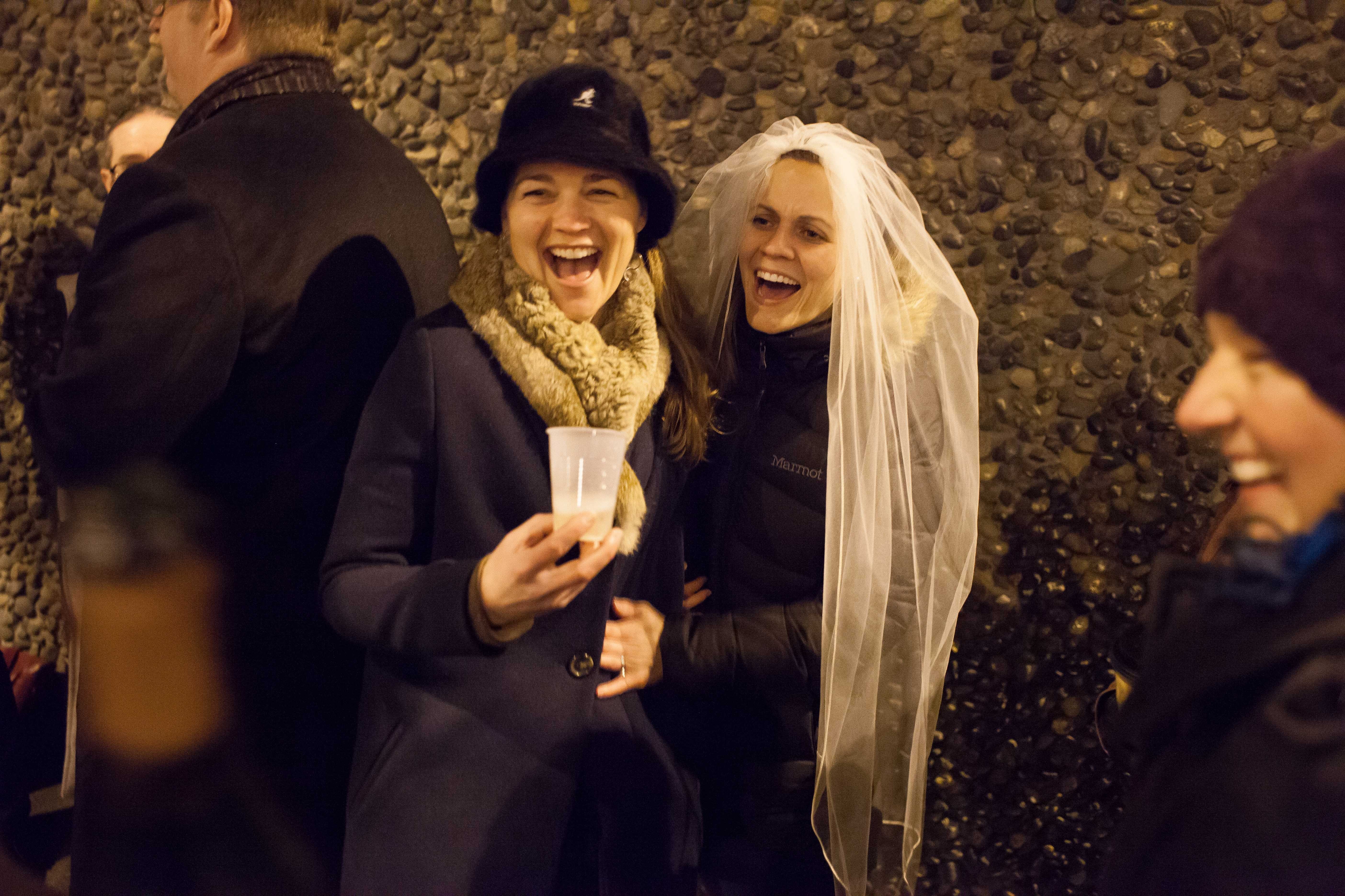 Jeri and Amy Andrews laugh as they wait in line outside of the King County Recorder's Office on Wednesday in Seattle, Washington.