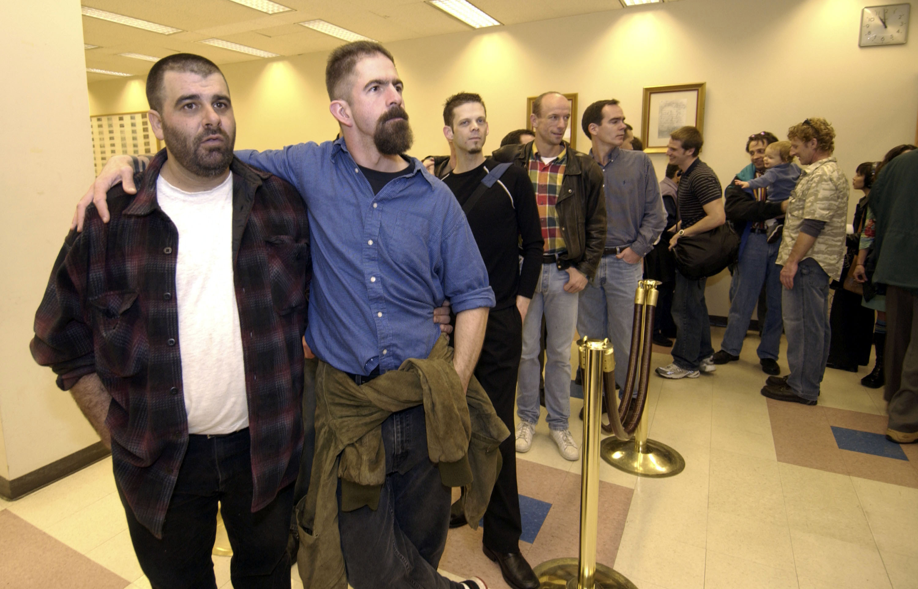 Will Gerome, left, and partner John Kirby wait their turn with other gay and lesbian couples to apply for a marriage license at the King County Administration Building in Seattle, Washington.