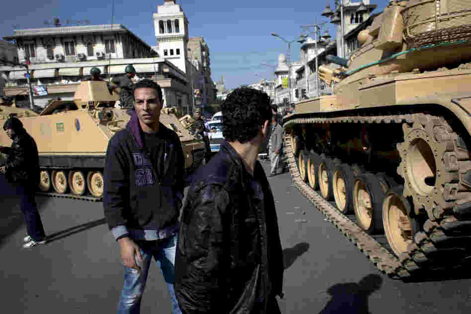 Egyptian army tanks deploy near the presidential palace after overnight clashes between supporters and opponents of President Mohammed Morsi in Cairo on Thursday.