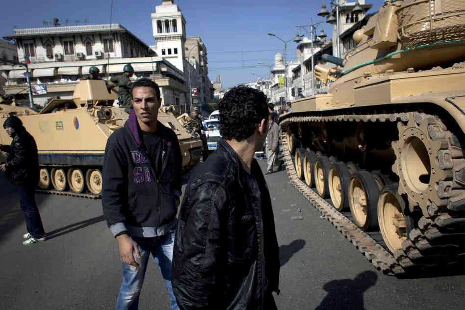 Egyptian army tanks deploy near the presidential palace after overnight clashes between supporters and opponents of President Mohammed Morsi in Cairo on Thursday.