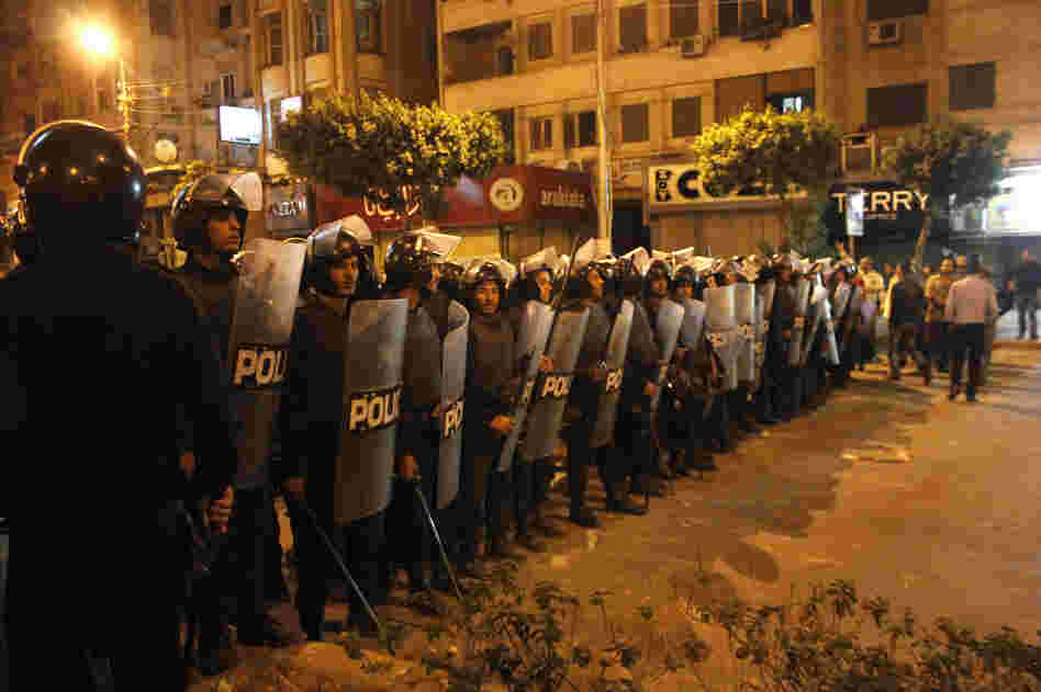 Egyptian riot police stand guard in Cairo on Wednesday during large-scale clashes that marked the worst violence of a deepening crisis over the disputed constitution.