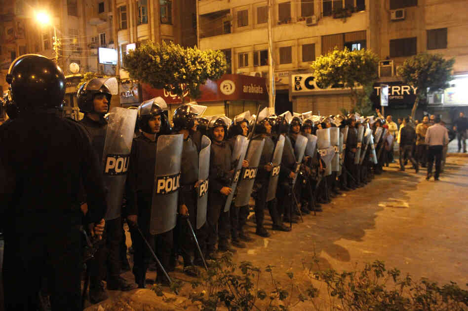 Egyptian riot police stand guard in Cairo on Wednesday during large-scale clashes that marked the worst violence of a deepening crisis over the disputed constitution.