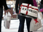 Shoppers carry bags during Black Friday sales at the South Shore Plaza in Braintree, Mass. Right now, consumers are feeling positive, but the mood among businesses is at recession levels. Shoppers carry bags during Black Friday sales at the South Shore Plaza in Braintree, Mass. Right now, consumers are feeling positive, but the mood among businesses is at recession levels.
