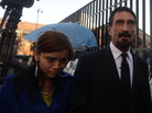 John McAfee, with a woman described as his girlfriend, on the way into the Supreme Court in Guatemala City on Tuesday. John McAfee, with a woman described as his girlfriend, on the way into the Supreme Court in Guatemala City on Tuesday.