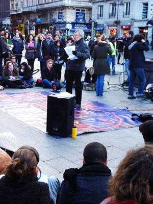Last week in Madrid's Puerta Del Sol square, a professor teaches a lesson outdoors while students take notes, all as a means of protesting education cuts.
