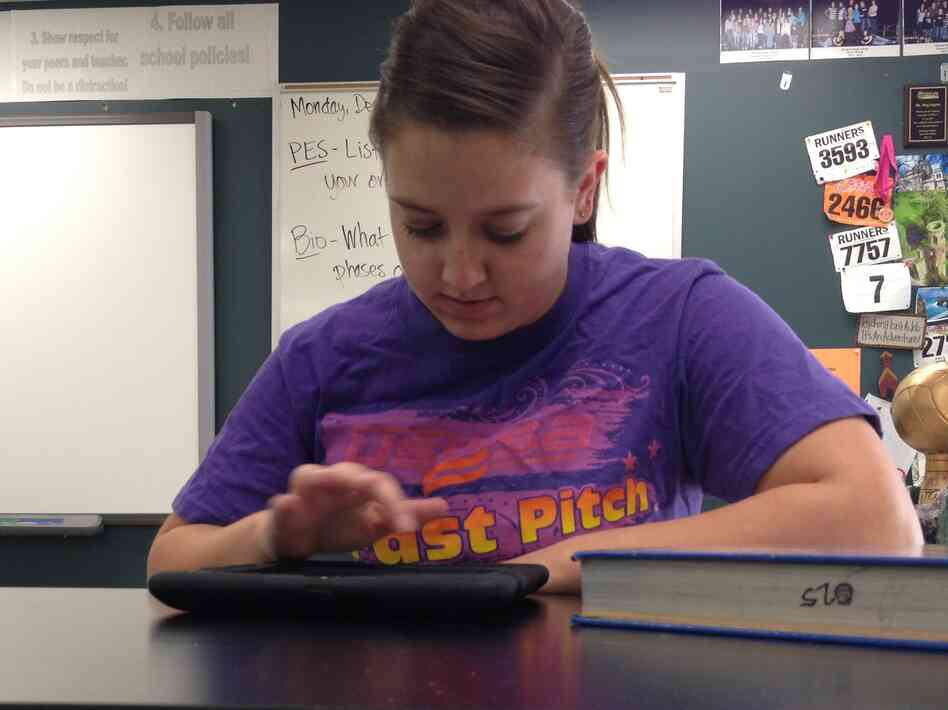 High school sophomore Jessica Miller watches her chemistry teacher's lectures on an iPad. Class time is used for working through problems and quizzes, rather than lecturing.