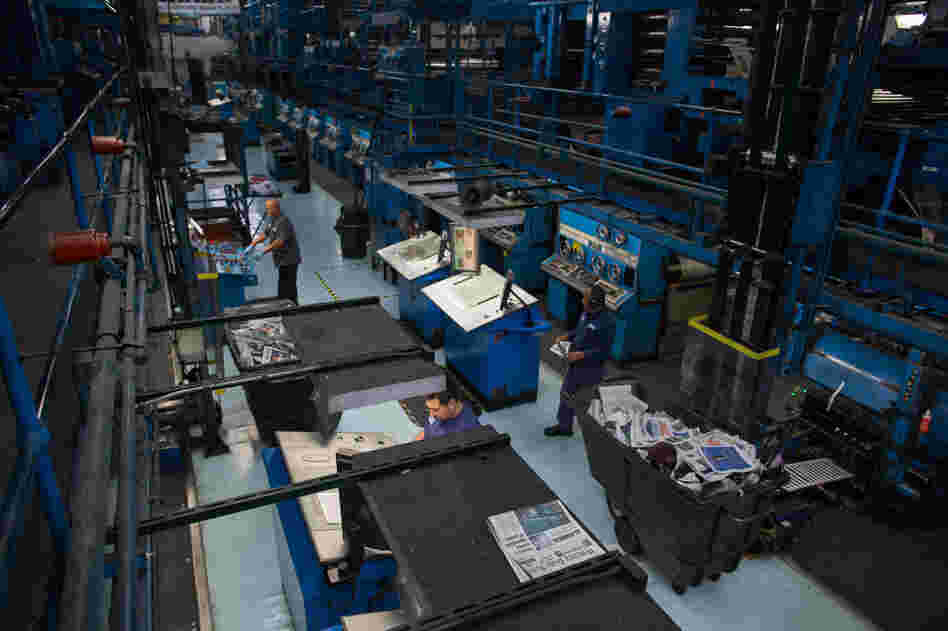 Workers in the pressroom at The Orange County Register in Santa Ana, Calif., where new owners are trying something unique in the industry: expanding the newsroom and putting the emphasis on print, not digital.