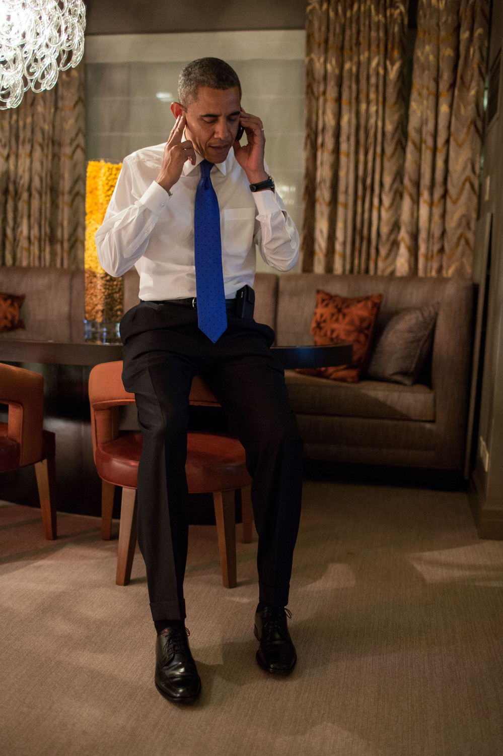 President Barack Obama talks on the phone with former Massachusetts Gov. Mitt Romney in the Presidential Suite at the Fairmont Chicago Millennium Park.