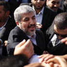 The exiled Hamas chief Khaled Mashaal shakes hands with supporters upon his arrival at Rafah crossing in the southern Gaza Strip.