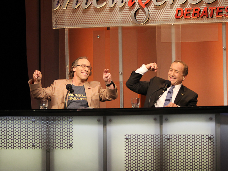 Lawrence Krauss and Michael Shermer react to their victory after arguing that 