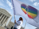 Same-sex marriage proponent Kat McGuckin of Oaklyn, N.J., holds a gay marriage pride flag in front of the Supreme Court Nov. 30, 2012. The court says it will review two cases related to same-sex marriage in 2013. Same-sex marriage proponent Kat McGuckin of Oaklyn, N.J., holds a gay marriage pride flag in front of the Supreme Court Nov. 30, 2012. The court says it will review two cases related to same-sex marriage in 2013.