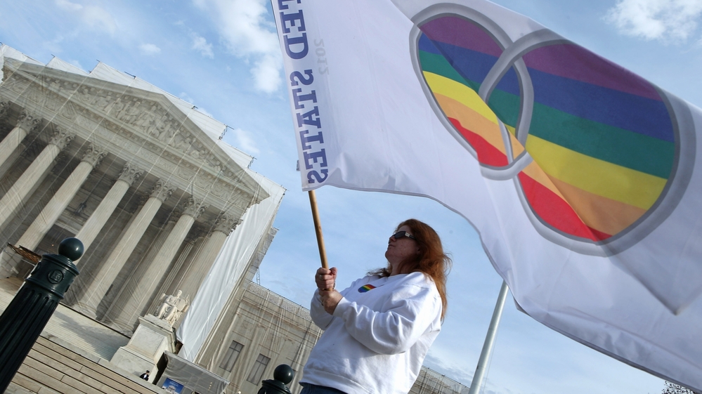 Same-sex marriage proponent Kat McGuckin of Oaklyn, N.J., holds a gay marriage pride flag in front of the Supreme Court Nov. 30, 2012 in Washington, D.C.