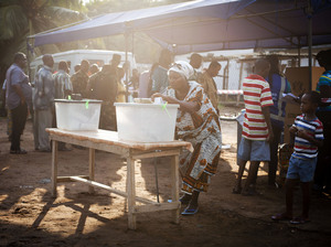 Lines were long at many polling stations in Ghana. Here a woman votes in the capital Accra.