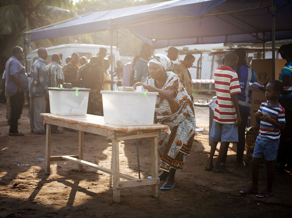 Lines were long at many polling stations in Ghana. Here a woman votes in the capital Accra.