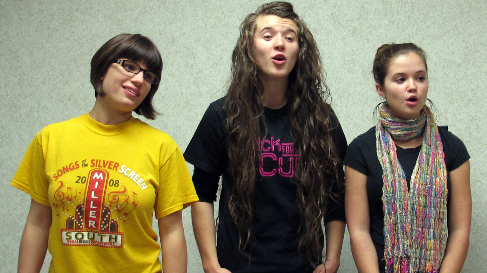 Three OHDELA students — from left, Hannah Fulks, Erika Blon and Randi Beatty — sing together. The online school's chorus meets for in-person practice once each quarter.