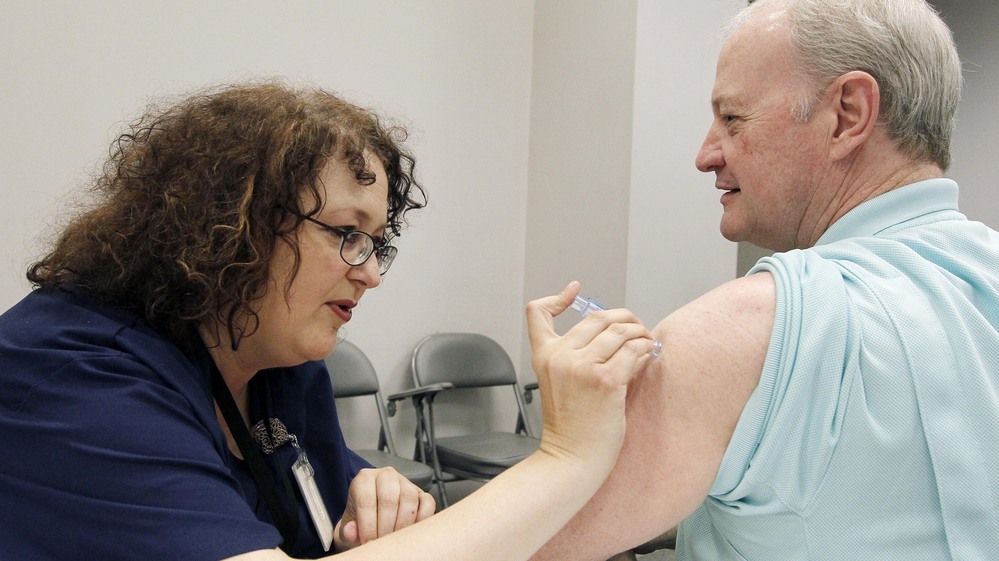 Bill Staples, a Mississippi health department worker, gets a flu shot in October. Mississippi is one of eight states where flu is already widespread this season.