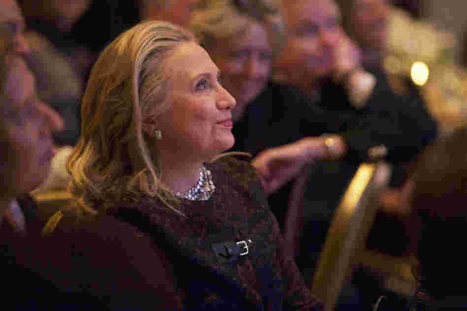 Secretary of State Hillary Clinton watches a video about her public life that was played before she addressed the Saban Forum in Washington last week.