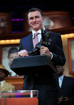 Quarterback Johnny Manziel of the Texas A&M University Aggies poses with the Heisman Memorial Trophy after being named the 78th Heisman winner Saturday in New York City. Quarterback Johnny Manziel of the Texas A&M University Aggies poses with the Heisman Memorial Trophy after being named the 78th Heisman winner Saturday in New York City.