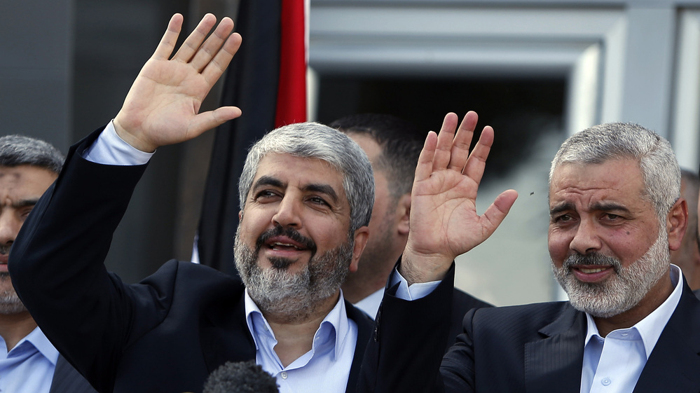 Exiled Hamas chief Khaled Mashaal (left) and Gaza's Hamas Prime Minister Ismail Haniyeh wave during a news conference upon Meshaal's arrival at Rafah crossing in the southern Gaza Strip on Friday.