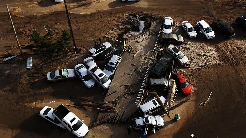 Abandoned and flooded cars sit in the heavily damaged Rockaway neighborhood in Queens, on Nov. 2, 2012 in New York. It's estimated that it could cost auto insurers $800 million to deal with all of the claims from the storm.