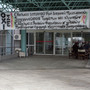 A hand-painted banner decrying drastic cuts to the health care budget is draped on the main entrance of the Regional Hospital of Serres in northern Greece.