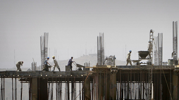 Laborers work on a building in Kabul, Afghanistan. Following the drawdown of U.S. troops and NGOs, many construction companies are without projects and being forced to close offices and downsize.