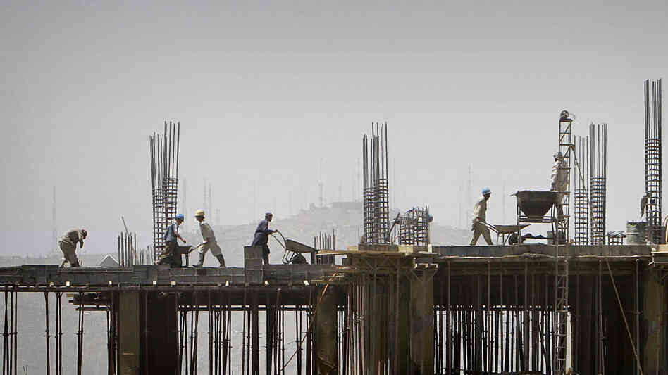 Laborers work on a building in Kabul, Afghanistan. Following the drawdown of U.S. troops and NGOs, many construction companies are without projects and being forced to close offices and downsize.