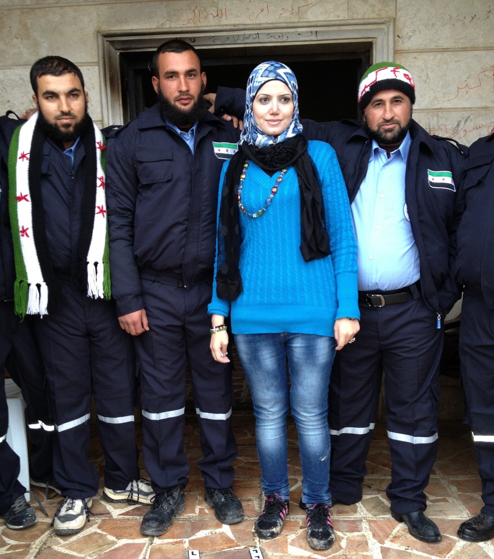 Razan Shalab Alsham, in bright blue, works for the Syrian Emergency Task Force. She helped provide uniforms for the  new civil police force of Khirbet al-Joz.