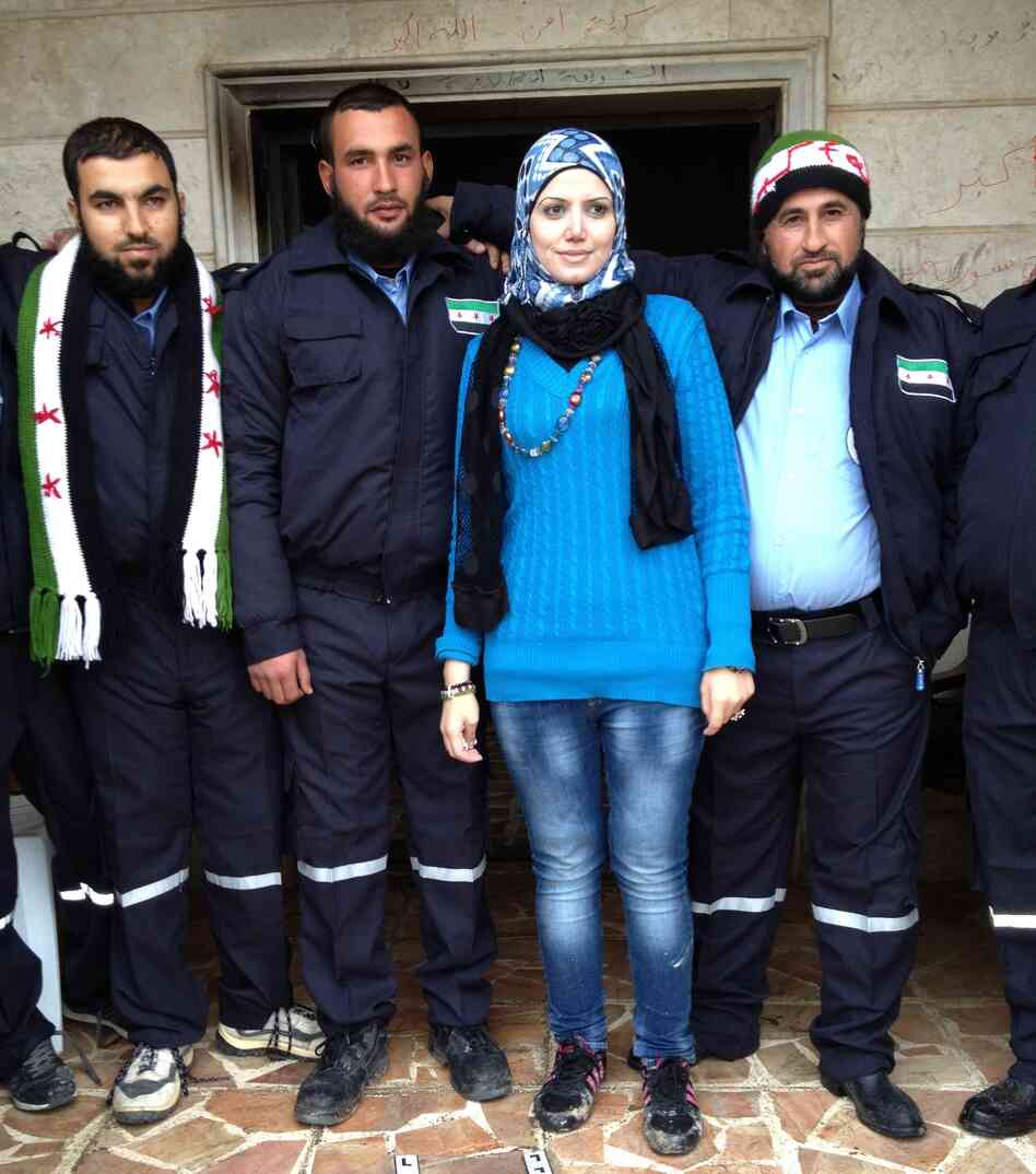 Razan Shalab Alsham, in bright blue, works for the Syrian Emergency Task Force. She helped provide uniforms for the  new civil police force of Khirbet al-Joz.